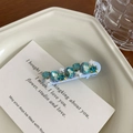 Detail view of light blue hair clip featuring teal crystals and white star accents - Blue Duckbill Clip (5cm)