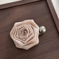 Detail of fabric rose hair claw with champagne petals and grey pearl on wood surface - Beige Duckbill Clip