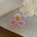 Detailed close-up of a pink bow-shaped hair claw clip with a strong golden metal spring - Bowknot Style Soft Pink / 8.5cm
