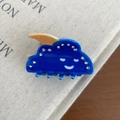 Close-up of blue cloud hair claw clip with rhinestones and orange moon on cream book - 5cm / Dark Blue