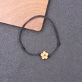 Handcrafted black woven lucky rope bracelet featuring a carved peach wood plum blossom charm - Black Rope Peach Blossom (BN-0257)