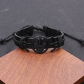 Punk black woven leather bracelet with metal Hamsa Hand charm on wooden base - Hamsa Hand