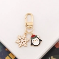Cartoon Christmas penguin keychain with gold clasp and white enamel snowflake charm - Snowflake + Penguin