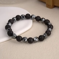 Close-up of porous black lava stone and faceted hematite beads on a minimalist bracelet - Lava Stone Style / Black