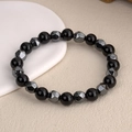 Faceted hematite and tiger eye beaded bracelet for men and women on white ceramic plate - Elastic Cord Obsidian Style / Black
