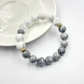 Dettaglio del bracciale in pietra vulcanica con perle di marmo bianco e inserti dorati - Stile Turchese Bianco e Pietra Paesaggio (10mm)