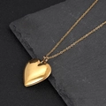 Detail view of a polished gold heart-shaped locket pendant with a classic sleek finish - Gold Smooth Heart Locket