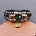 Dettaglio macro del bracciale Capricorno in pelle multistrato con ciondoli in bronzo - Capricorno