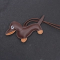Detailed close-up of brown and orange handmade leather dachshund bag charm with stitching - Dark Brown