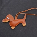 Detail of a brown leather dachshund puppy keychain with premium handmade stitching - Tan