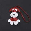 Detail of a handmade Schnauzer leather charm with white stitching and a red leather strap - Burgundy