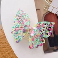 Macro shot of large butterfly hair claw clip with floral print and gold spring detail - Green Purple / 14cm