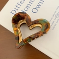 Macro detail of amber acetate heart hair claw clip with durable metal spring mechanism - Amber 6cm