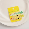 Detail of two-piece acrylic hair clip set with green plaid and glitter polka dot patterns - Yellow Series