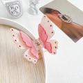 Detail of elegant double-layered pink butterfly hair claw clip with sparkly rhinestones - Orange