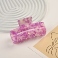 Close-up of a rectangular purple marble acetate hair claw clip on a white display tray - Purple and White Marble