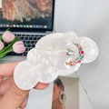 Detail view of pearl white cloud hair claw clip with colorful moon and star rhinestones - Diamond White-Moon Star