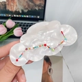 Pearlescent white acetic cloud hair claw with colorful rhinestones in a lifestyle setting - Mermaid White - Big Dipper (8.5cm)