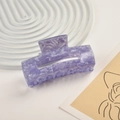Close-up of a purple marble texture acetate hair claw clip on a minimalist white tray - Purple Mica Pattern