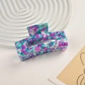 Floral pattern acetate hair claw clip shown in a modern lifestyle flat lay setting - Purple Cyan Floral Pattern