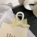 Detail of a translucent yellow bow hair claw clip with frosted texture and white base - 8.5cm / Creamy White With Yellow Bow