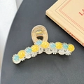 Close-up of a large clear acrylic hair claw clip with five bright yellow pineapple motifs - Pineapple (13cm)