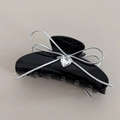 Detail of black acetate hair claw with silver ribbon bow and heart-shaped gemstone - 10cm / Black