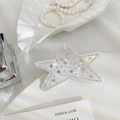 Detailed close-up of a star-shaped hair claw with sparkling rhinestones and pearl finish - White 7CM