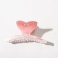 Macro detail of a pink heart-shaped acetate hair claw with a smile and Happy text - Heart Claw Clip