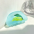 Macro detail of translucent light blue hair claw clip with yellow and green leaf patterns - Green Leaf / Blue