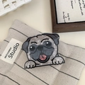 Detail view of a pug dog acetate hair claw clip on a minimalist textured fabric background - Pug