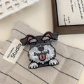 Detail view of Schnauzer hair claw clip with acetate texture on soft fabric background - Schnauzer