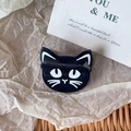 Detailed close-up of a cute black cat enamel pin on rustic vintage paper background - Black Cat Style