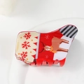 Détail d'une pince à cheveux de Noël rouge et blanche avec des motifs de renne et de flocon de neige - Renne