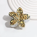 Detailed macro view of a leopard print flower hair claw clip with a glossy resin finish - Yellow Leopard