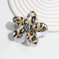 Detail of leopard print flower hair claw clip with transparent teeth and glossy finish - Black & White Leopard
