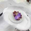 Detail of cute brown bear hair claw clip with purple floral dress on a white display stand - Teddy Bear