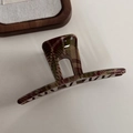 Detailed close-up of a glossy red and green tartan plaid claw clip with high-shine finish - Light Red Green Plaid - Hollow Straight (Approx 12.5cm)