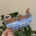 Cute sea otter hair claw clip in light blue translucent acetate with wavy texture - Blue Otter