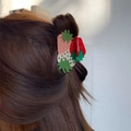 Detail view of a red strawberry hair claw clip worn on long brown hair for styling - Pink Red White Strawberry