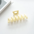 Macro shot of cream matte wavy hair claw clip showing durable metal spring and modern design - Off White