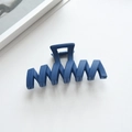 Detail of navy blue matte hair claw clip with wave pattern and strong metal spring - 11.3cm / Blue