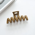 Close-up of a large matte khaki wave hair claw clip for thick hair styling - 11.3cm / Khaki