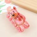 Close-up of pink strawberry bear hair claw clip with iridescent acrylic finish - Pink Cute Bear