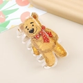 Golden bear hair claw clip with red heart bow tie on a clean aesthetic background - Ginger Yellow Cute Bear