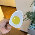 Detailed close-up of a poached egg style claw clip made of glossy acetate material - Egg Yolk Yellow