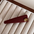 Close-up of a burgundy fabric hair clip with a gold Korea embossed metallic label - Gold Label Red - Triangular Snap Clip
