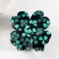 Top view of a clover-shaped hair claw clip with light green floral patterns on black - Black with Green Shamrocks (A6-2-9)