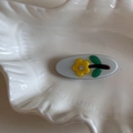 Detail of jelly colored oval hair clip with small yellow flower and sparkling rhinestone - Blue