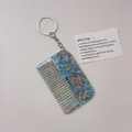 Detail of blue marble acetate hair comb keychain with silver metal ring and prop card - Blue (Silver Chain)